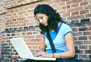  2023/06/Young-woman-on-laptop-edit-1.jpeg 